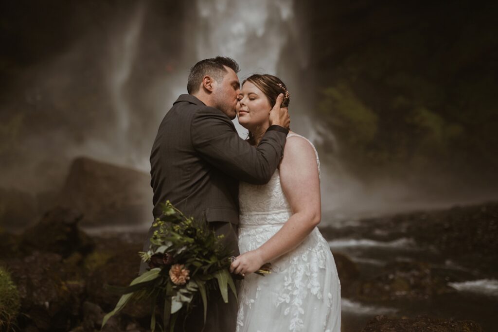 bride and groom at waterfall in iceland