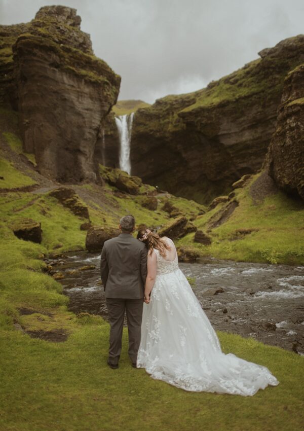 bride and groom at waterfall in iceland