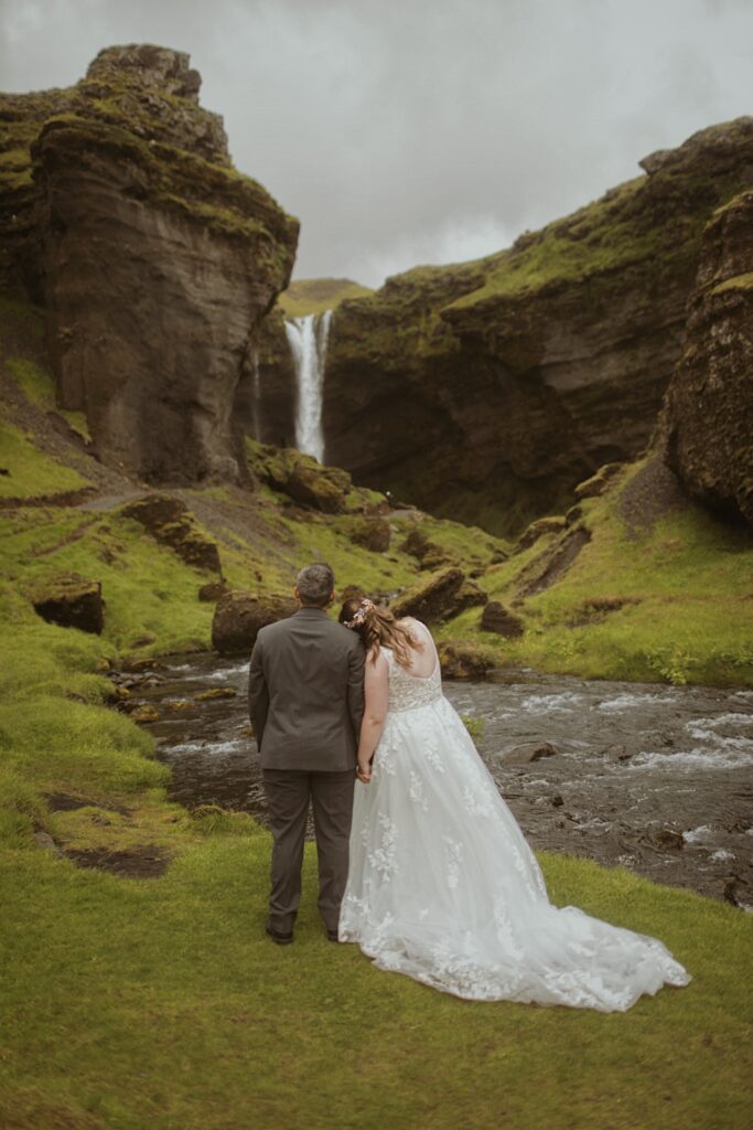 bride and groom at waterfall in iceland