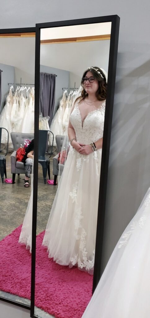 bride looking in mirror in long beach california bridal shop