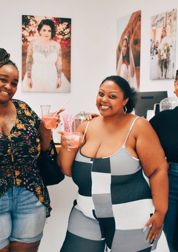 plus size women of color drinking champagne in a bridal shop near me