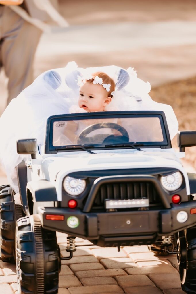 flower girl driving tiny jeep