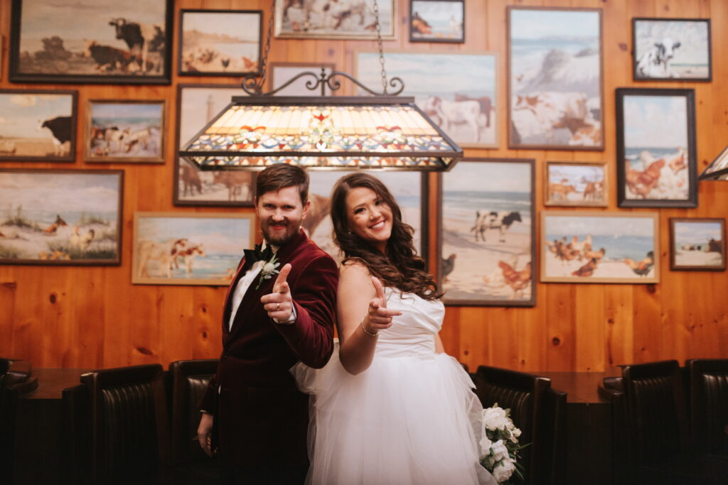 bride in wedding dress with overskirt with groom in velvet tux