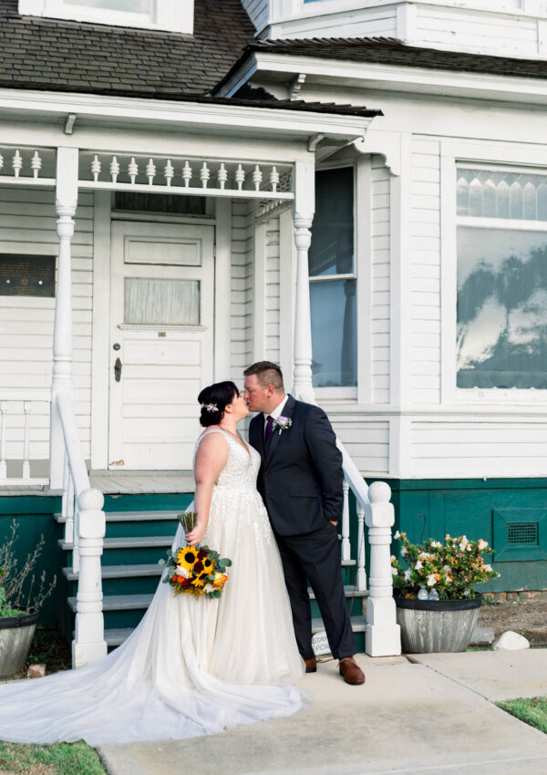 bride and groom in front of rustic house huntington beach california