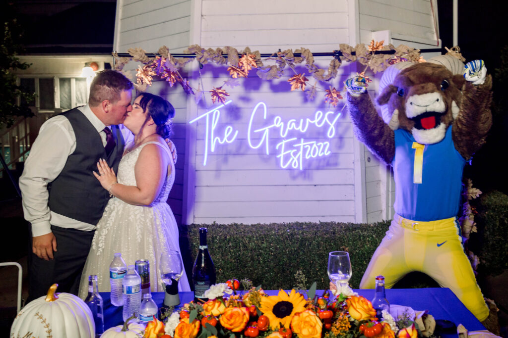 bride and groom at sweetheart table with rams mascot