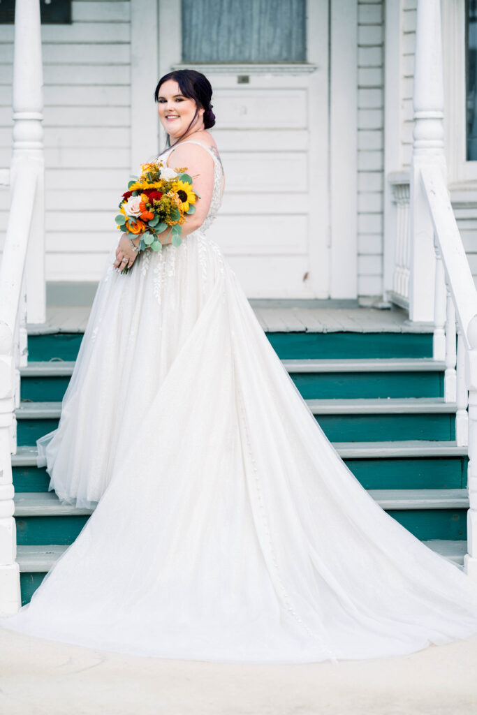bride wearing tulle aline wedding dress on stairs