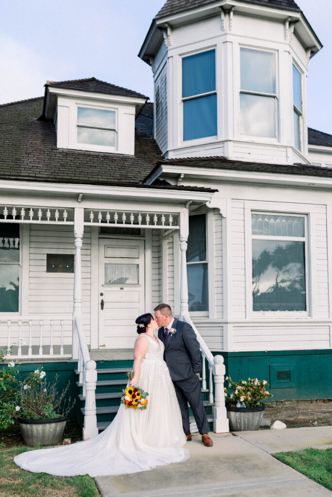 bride and groom in front of rustic house huntington beach california