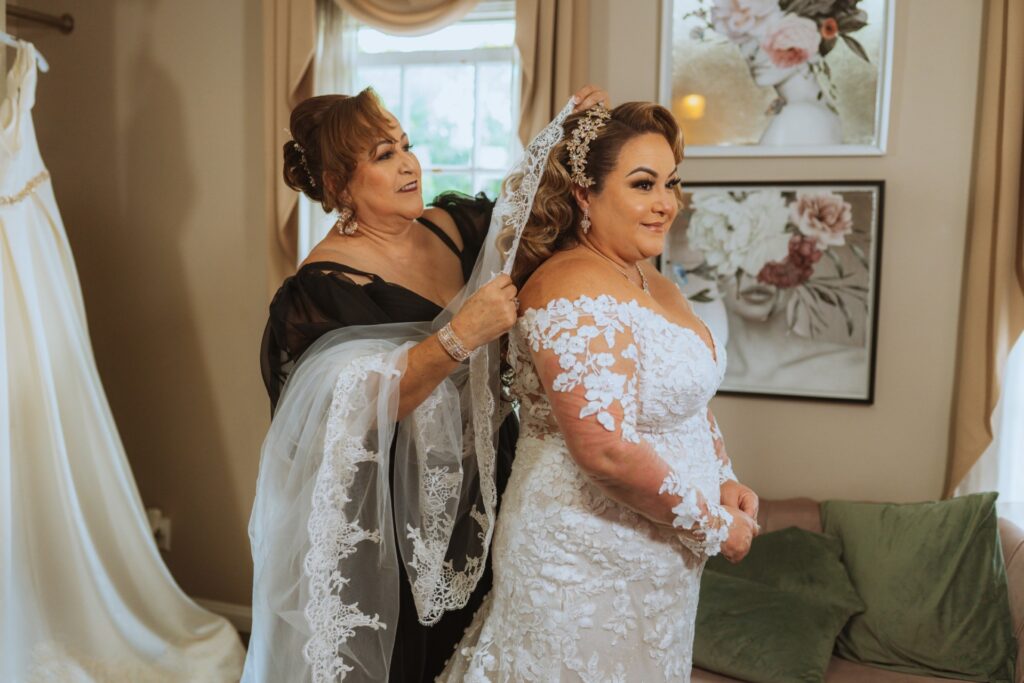 plus size bride wearing long sleeve lace fitted wedding dress with long dramatic lace train