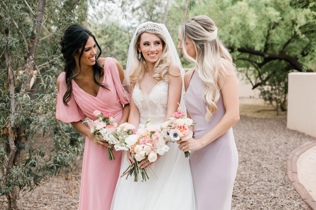 2 petite girls in blush bridesmaid dresses with bride in chandler arizona