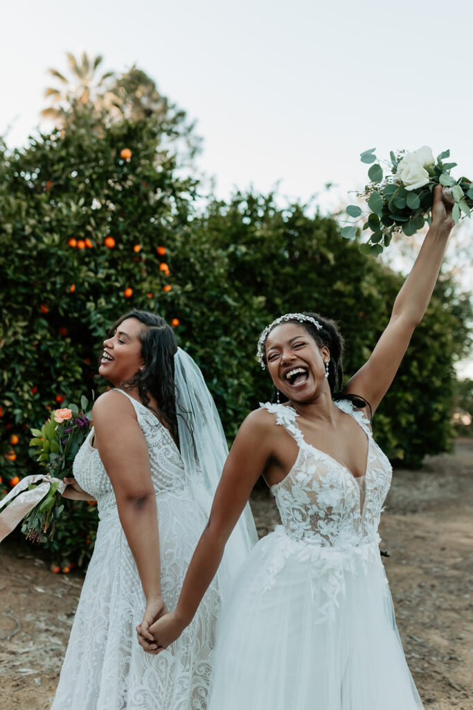 two brides in wedding dresses lgqbtqia+ wedding dress