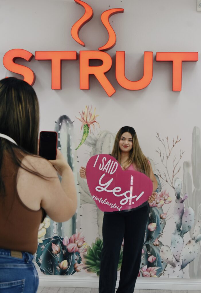 bride holding say yes to the dress sign in chandler arizona bridal store