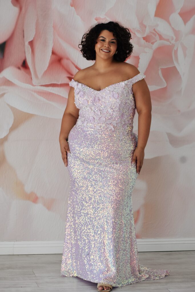 plus size woman wearing off the shoulder plus size sequin sheath prom dress in chandler arizona bridal store