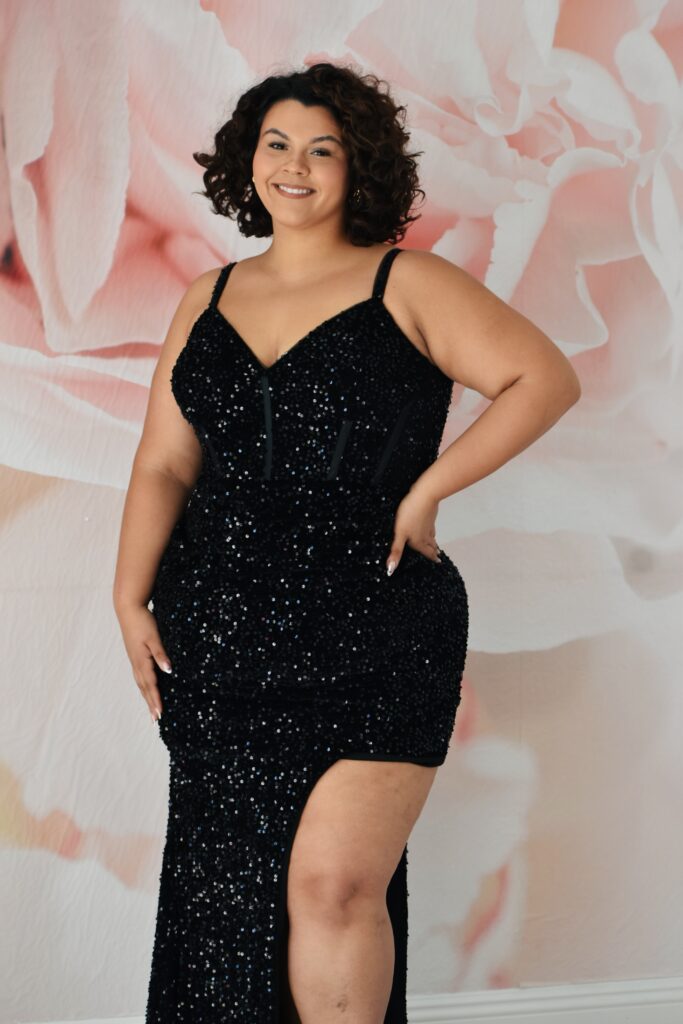 plus size girl wearing black prom dress in chandler arizona bridal shop