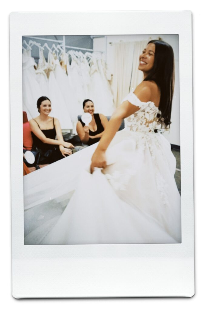 smiling bride twirling in wedding dress in long beach california bridal shop