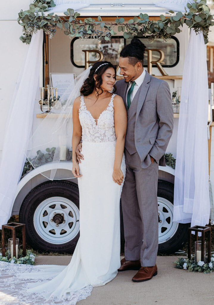 bride wearing crepe wedding dress with groom in gray suit phoenix arizona