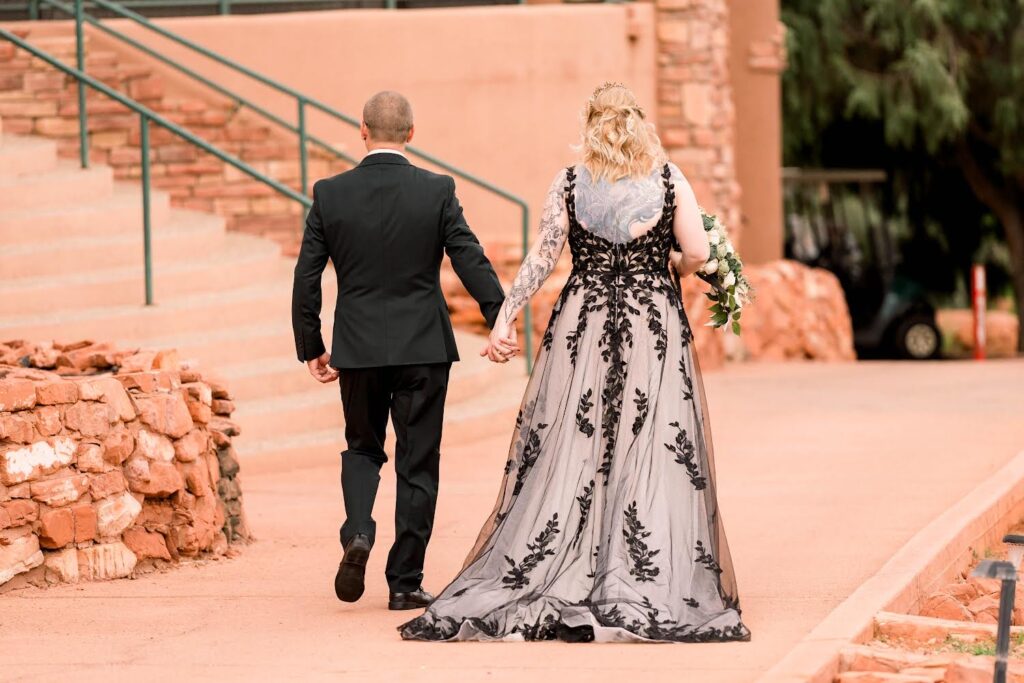 bride wearing two tone lace aline wedding dress, groom in black tux in sedona arizona