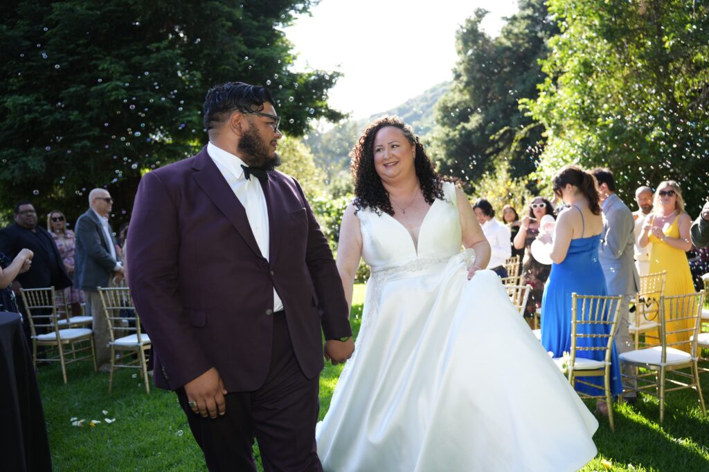 plus size bride wearing vneck mikado wedding dress groom in suit at woodsy park