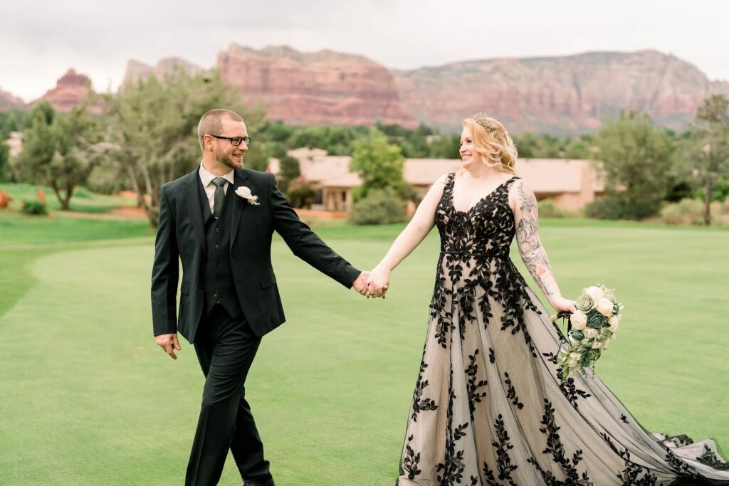 bride wearing two tone lace aline wedding dress, groom in black tux in sedona arizona