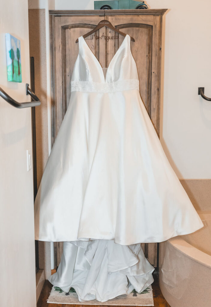 plus size mikado aline wedding dress hanging in Flagstaff arizona barn