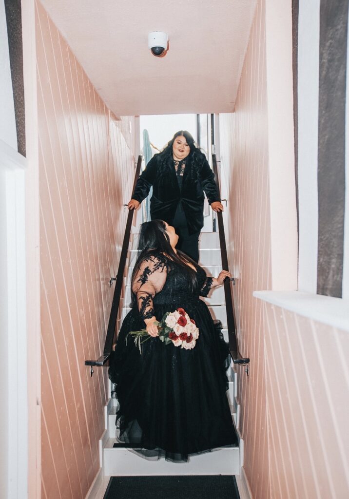 plus size black wedding dress on bride in stairwell