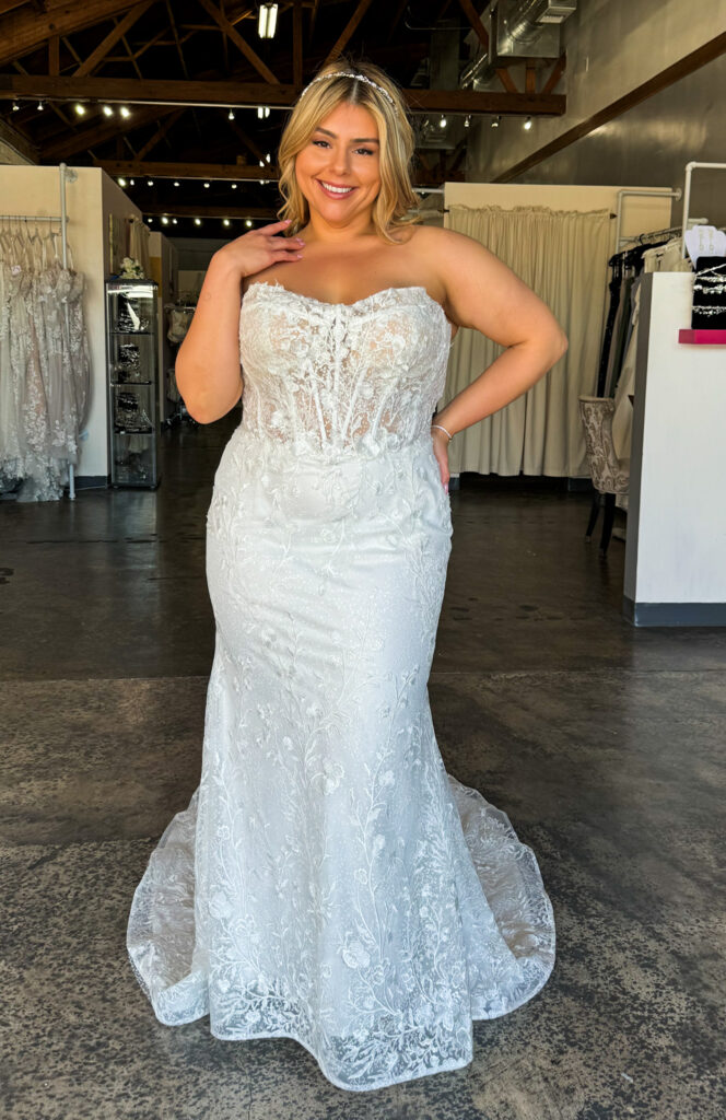 woman wearing plus size fitted off the rack wedding dress under 1000 in long beach california bridal shop