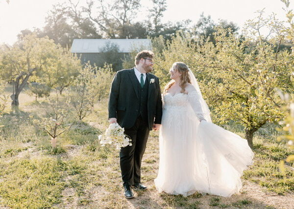 bride wearing plus size aline wedding dress with groom in tux