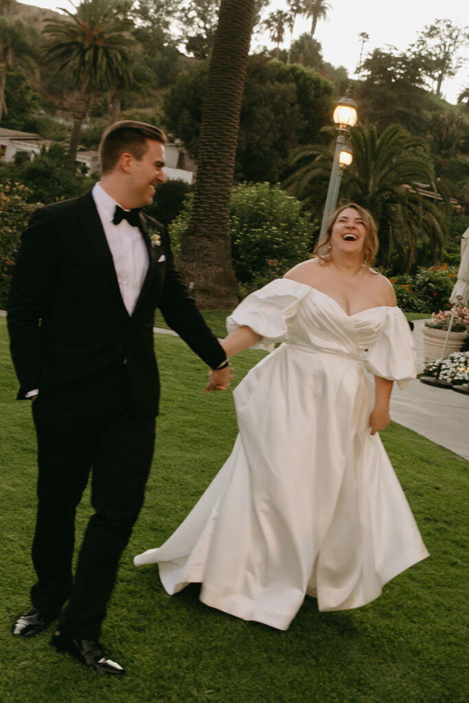 mid size bride wearing classic satin aline wedding dress with puff sleeves