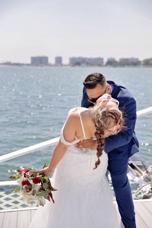 bride wearing fitted lace wedding dress on a catamaran in san diego california
