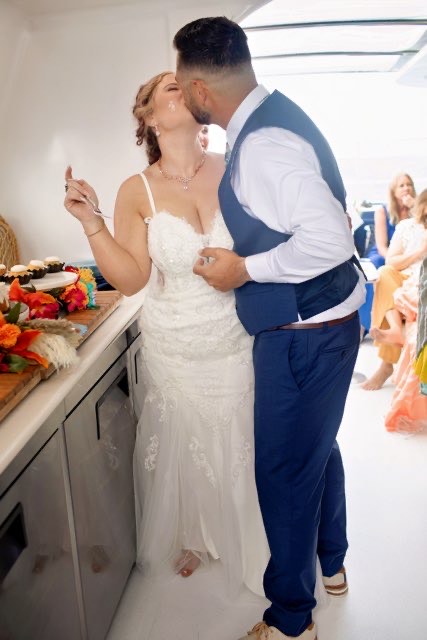 bride wearing fitted lace wedding dress on a catamaran in san diego california