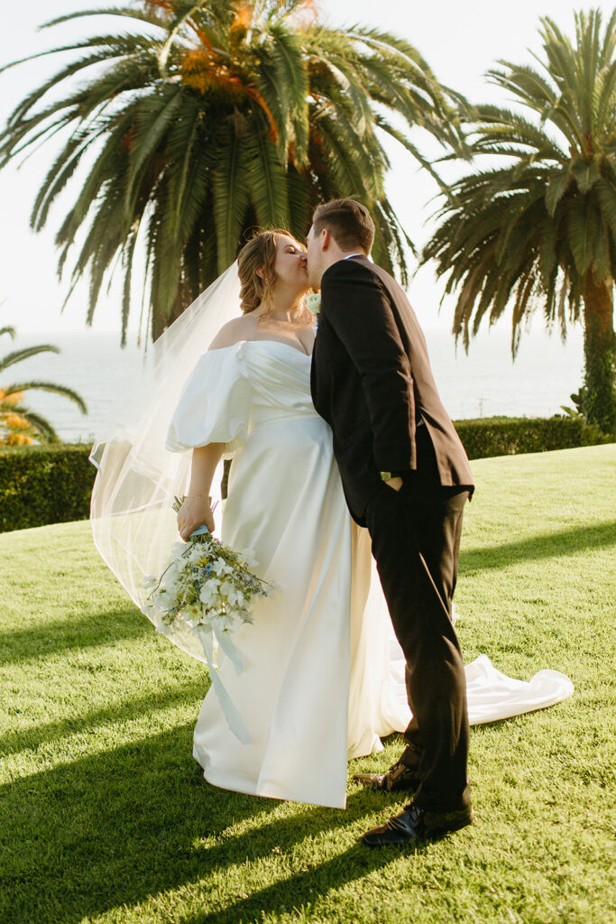 mid size bride wearing classic satin aline wedding dress with puff sleeves