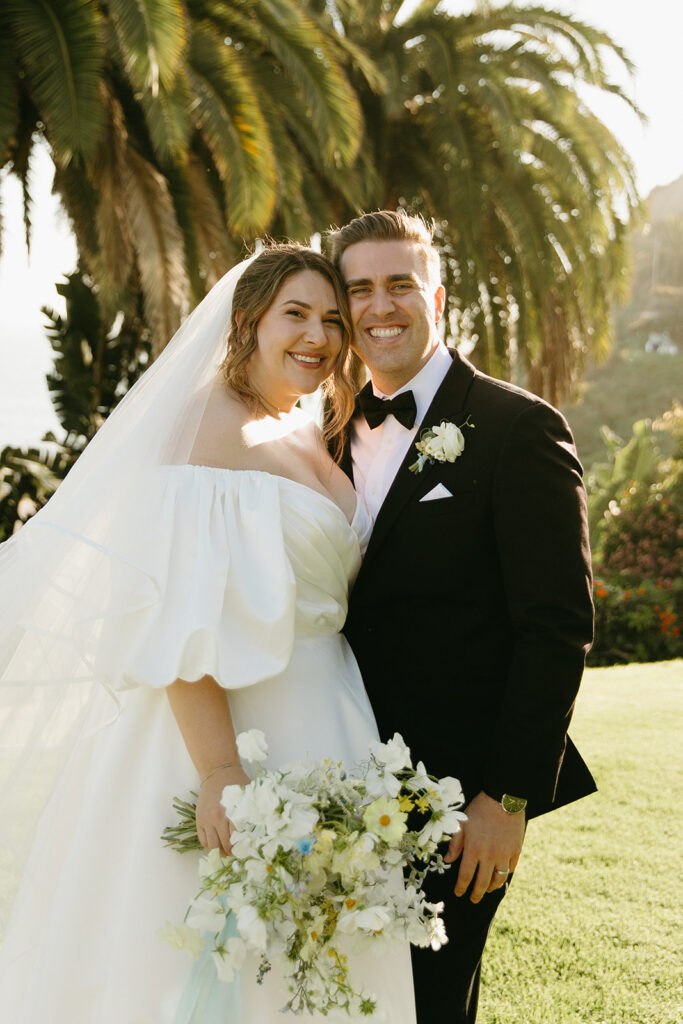 mid size bride wearing classic satin aline wedding dress with puff sleeves