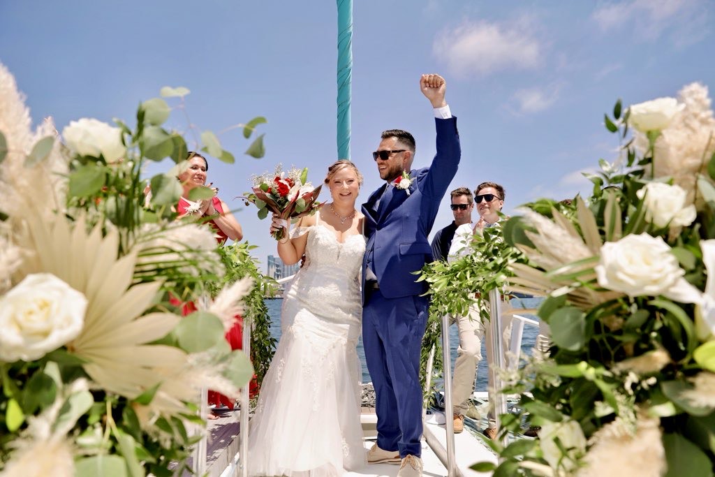 bride wearing fitted lace wedding dress on a catamaran in san diego california