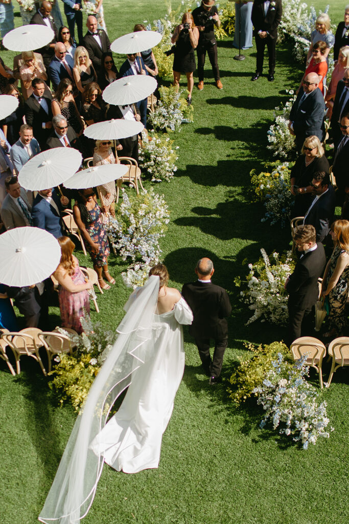 bride walking down the aisle with cathedral veil